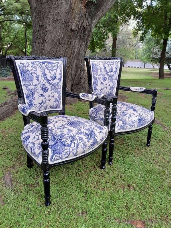A Pair Of 20th Century French Louis XVI Styled Ornately Carved And Gilded Arm Chairs