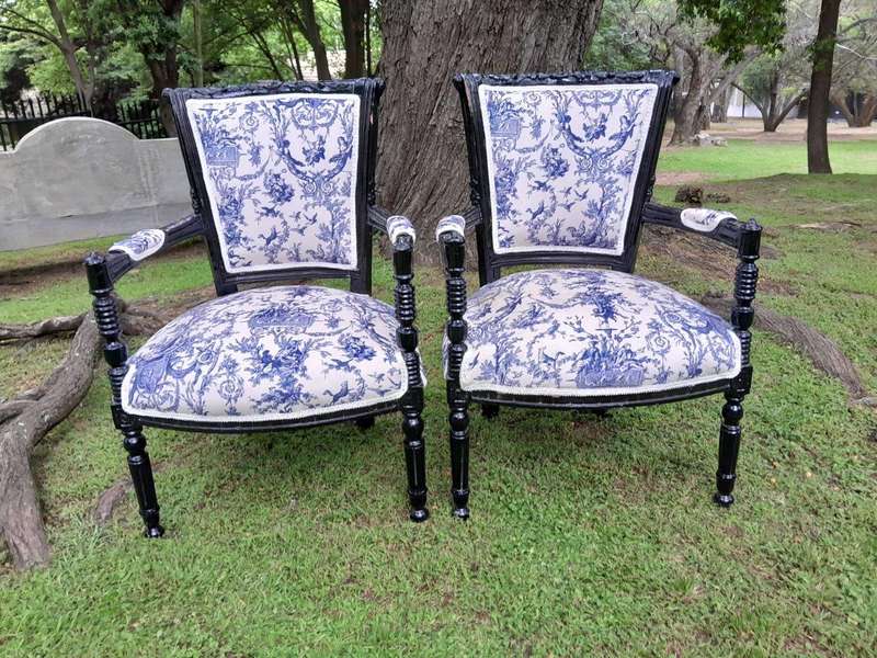 A Pair Of 20th Century French Louis XVI Styled Ornately Carved And Gilded Arm Chairs
