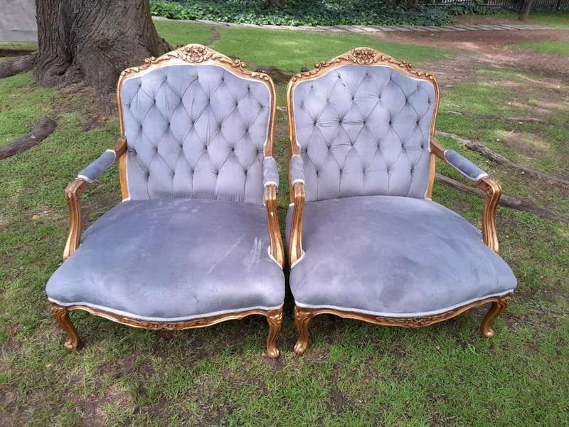 A French Style Pair Of Ornately Carved Gilt Wood Armchairs
