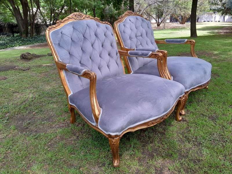 A French Style Pair Of Ornately Carved Gilt Wood Armchairs