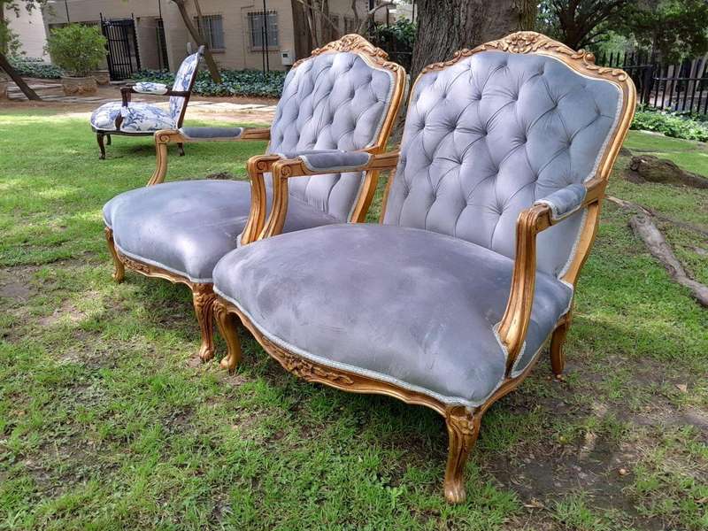 A French Style Pair Of Ornately Carved Gilt Wood Armchairs
