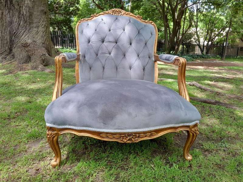 A French Style Pair Of Ornately Carved Gilt Wood Armchairs