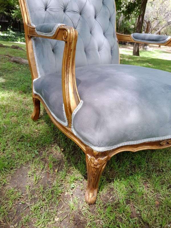 A French Style Pair Of Ornately Carved Gilt Wood Armchairs