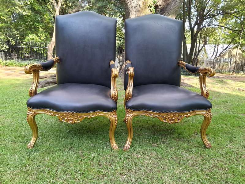 A 20TH Century Pair Of French Style Carved and Giltwood High Back Armchairs Upholstered in Leather