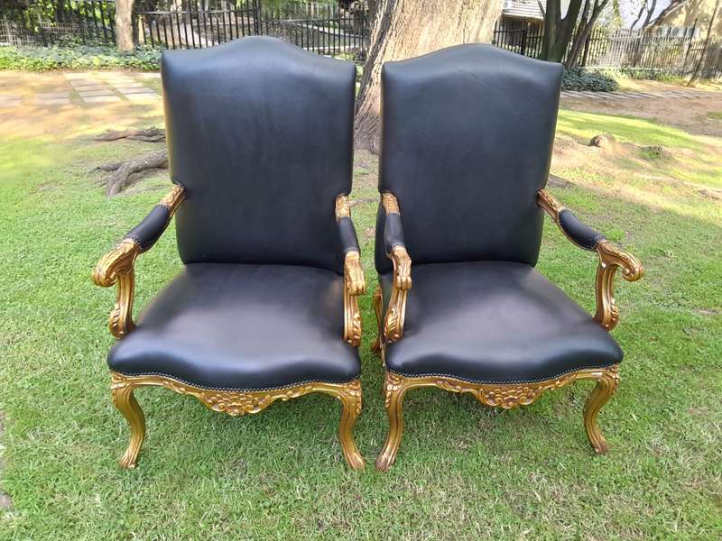 A 20TH Century Pair Of French Style Carved and Giltwood High Back Armchairs Upholstered in Leather