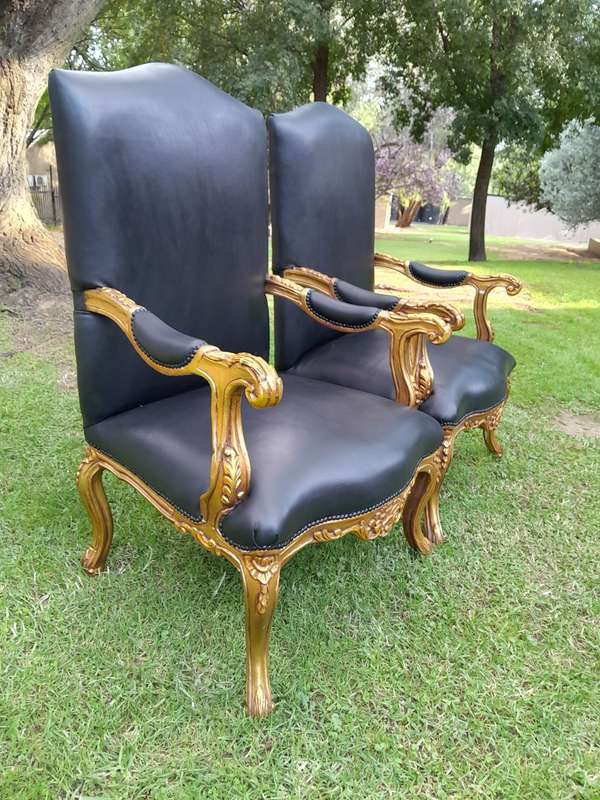 A 20TH Century Pair Of French Style Carved and Giltwood High Back Armchairs Upholstered in Leather