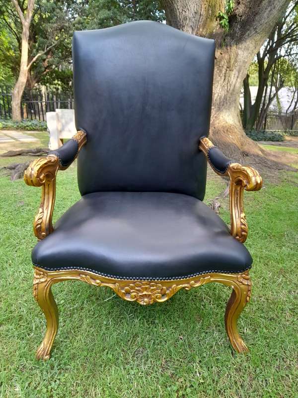 A 20TH Century Pair Of French Style Carved and Giltwood High Back Armchairs Upholstered in Leather