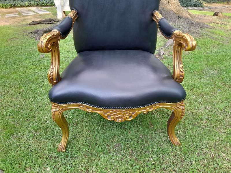 A 20TH Century Pair Of French Style Carved and Giltwood High Back Armchairs Upholstered in Leather