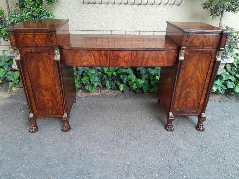 A George III Circa 1820 Mahogany / Flame Mahogany With Parcel Gild Sideboard With Two Cellarette ...