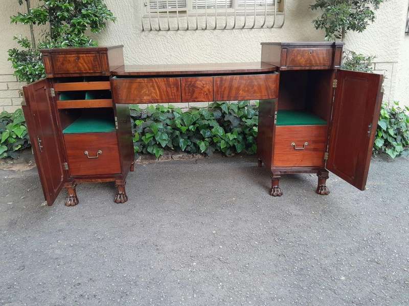 A George III Circa 1820 Mahogany / Flame Mahogany With Parcel Gild Sideboard With Two Cellarette ...