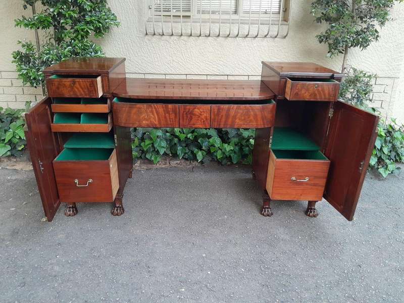 A George III Circa 1820 Mahogany / Flame Mahogany With Parcel Gild Sideboard With Two Cellarette ...