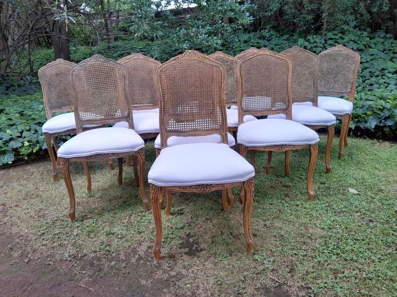 A Rare 20th Century Set Of Twelve French Colonial Style Walnut Rattan Dining Chairs