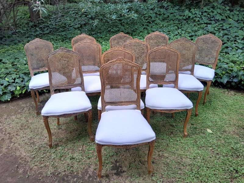 A Rare 20th Century Set Of Twelve French Colonial Style Walnut Rattan Dining Chairs