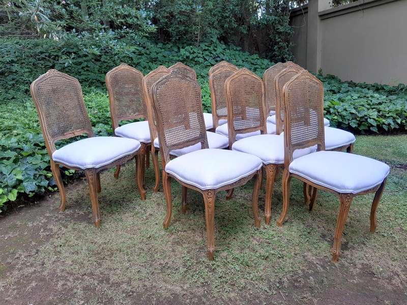 A Rare 20th Century Set Of Twelve French Colonial Style Walnut Rattan Dining Chairs