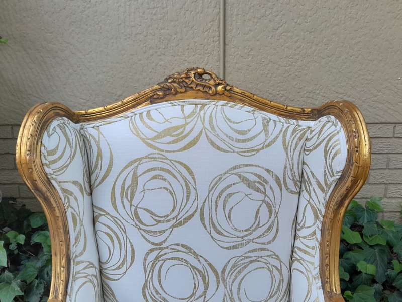 A French Style Pair of Hand Gilded Carved Wingback Chairs Upholstered in a Custom Made for The Cr...