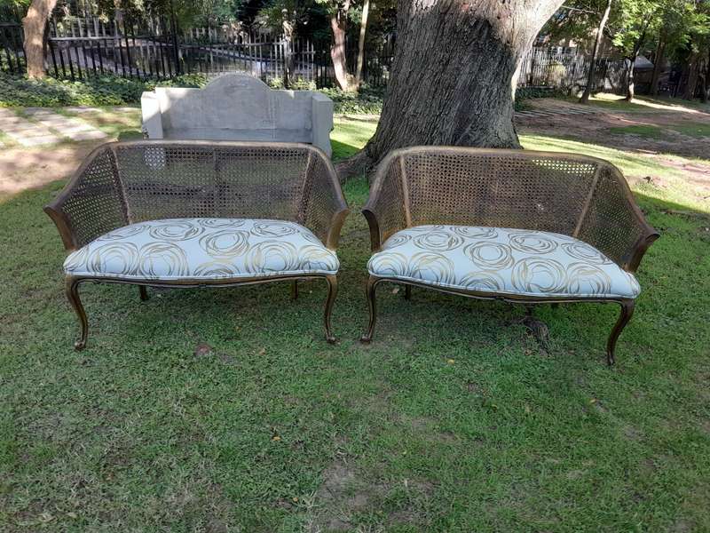 A Pair of French Style Carved and Gilded Wooden and Rattan Settees Upholstered in a Custom-Made L...