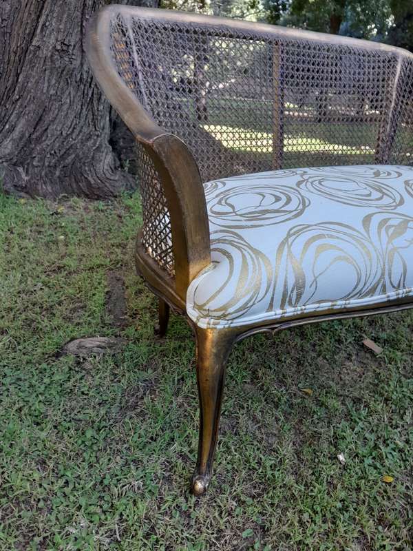 A Pair of French Style Carved and Gilded Wooden and Rattan Settees Upholstered in a Custom-Made L...