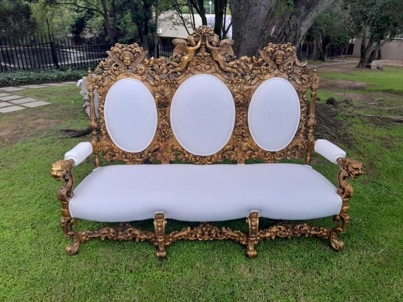 A 19th Century Ornately Carved Walnut Wood Settee Hand Gilded With Gold Leaf And Upholstered In A...
