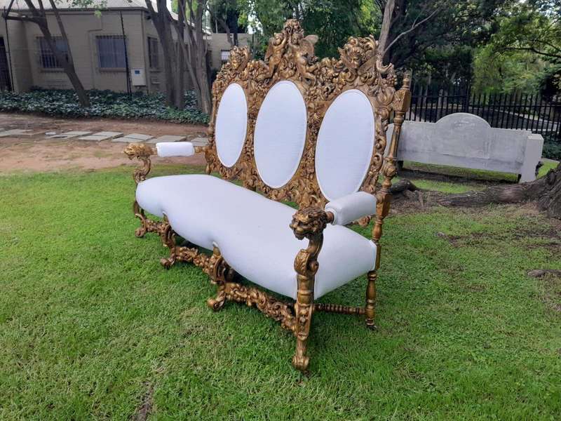 A 19th Century Ornately Carved Walnut Wood Settee Hand Gilded With Gold Leaf And Upholstered In A...