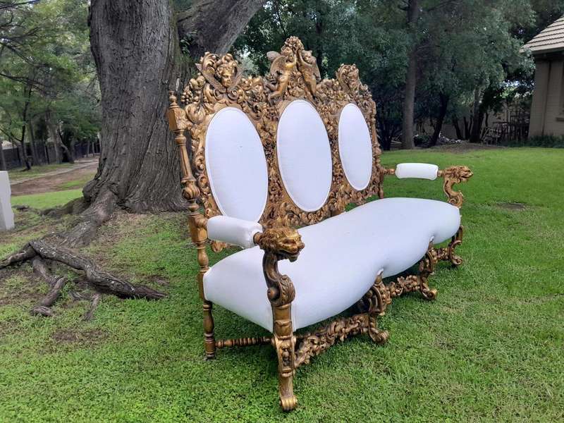 A 19th Century Ornately Carved Walnut Wood Settee Hand Gilded With Gold Leaf And Upholstered In A...