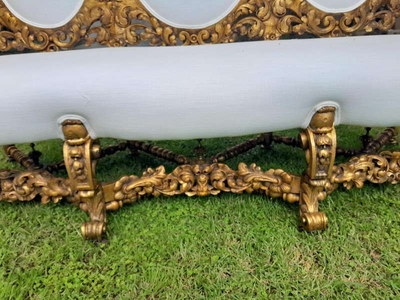 A 19th Century Ornately Carved Walnut Wood Settee Hand Gilded With Gold Leaf And Upholstered In A...