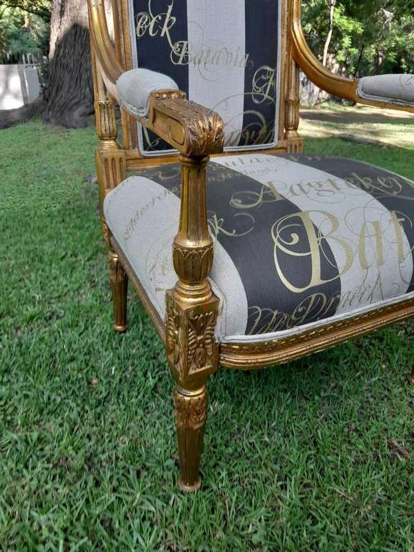 A French Style Set Of Four Ornately Carved And Gilded Armchairs In A Custom-Made Stripe And Scrip...