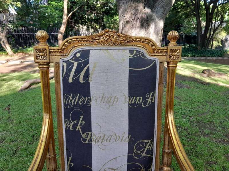 A French Style Set Of Four Ornately Carved And Gilded Armchairs In A Custom-Made Stripe And Scrip...