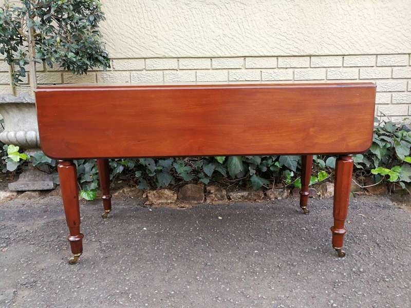 An Early 20th Century Mahogany Pembroke Table On Turned Legs