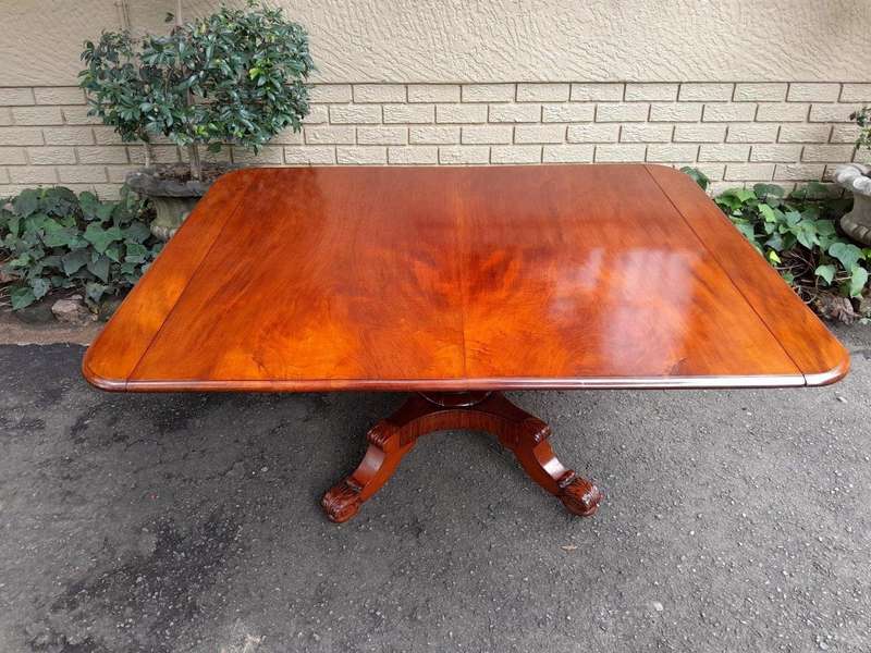 An Antique William IV Breakfast Table With Hinged Top On Castors