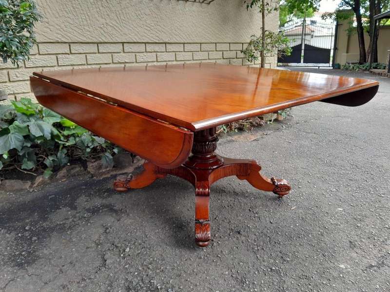 An Antique William IV Breakfast Table With Hinged Top On Castors
