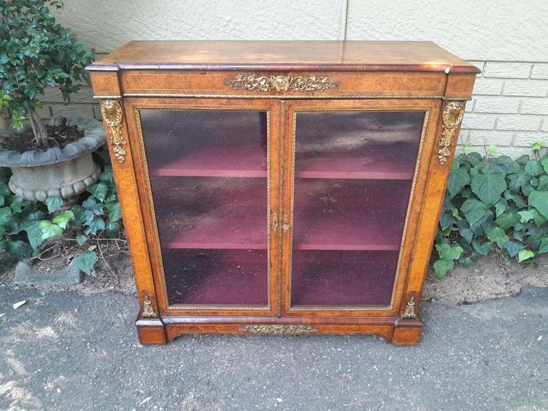 A Victorian Walnut Credenza / Display Cabinet With Gilt Mounts And Glazed Doors With Shelves On B...