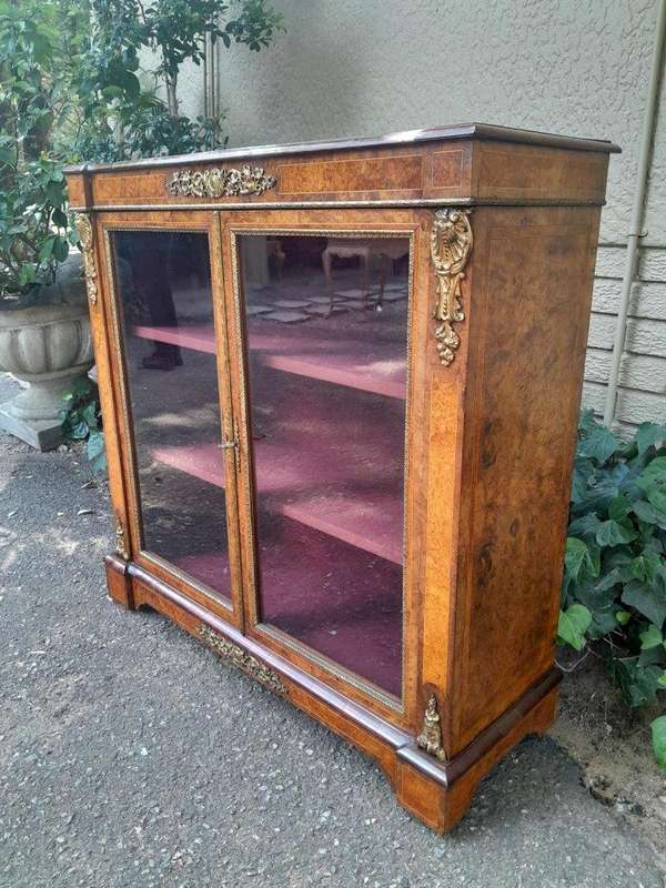 A Victorian Walnut Credenza / Display Cabinet With Gilt Mounts And Glazed Doors With Shelves On B...