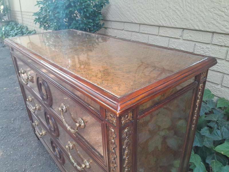 A Theodore Alexander Verre Églomisé Chest With Three Drawers And Brass Decoration