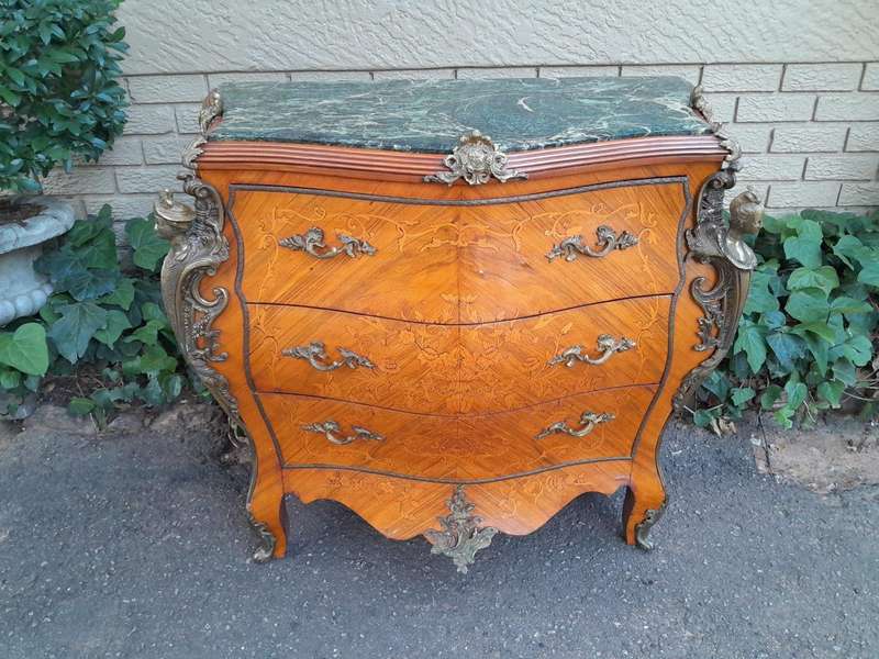 A 20th Century French Style Bombe Chest Of Drawers With Marble Top And Gilt Mounts