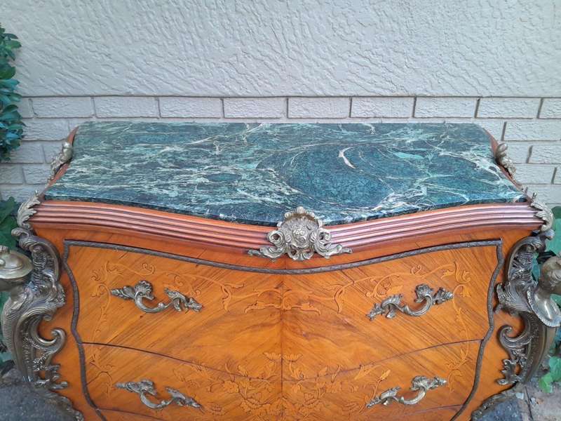 A 20th Century French Style Bombe Chest Of Drawers With Marble Top And Gilt Mounts