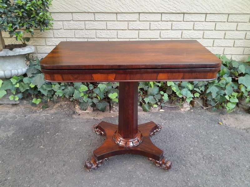 A Victorian rosewood swivel and tilt CARD TABLE, on spreading hexagonal column to the concave pla...