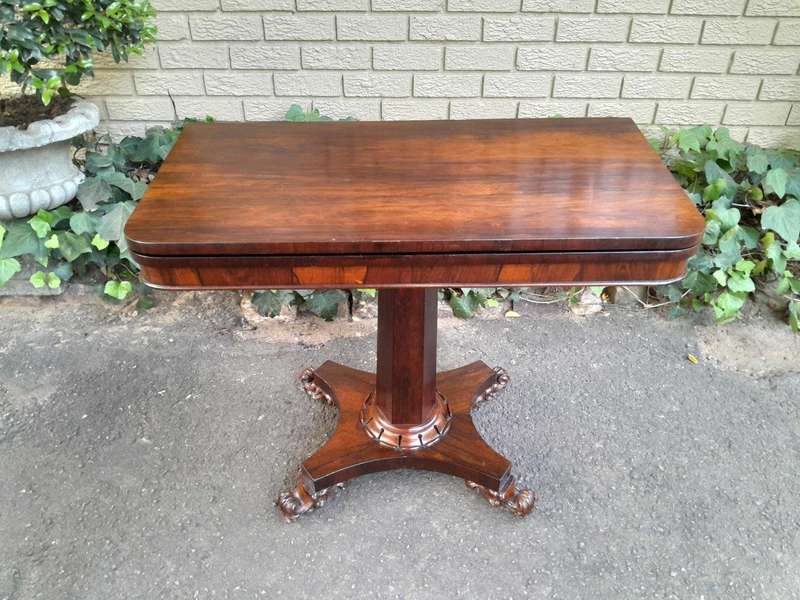 A Victorian rosewood swivel and tilt CARD TABLE, on spreading hexagonal column to the concave pla...