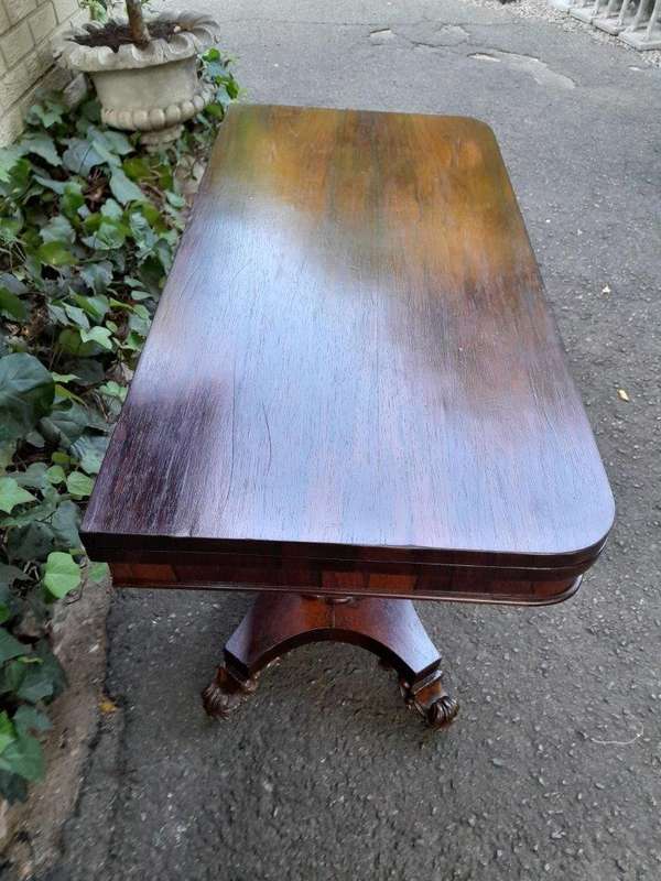 A Victorian rosewood swivel and tilt CARD TABLE, on spreading hexagonal column to the concave pla...