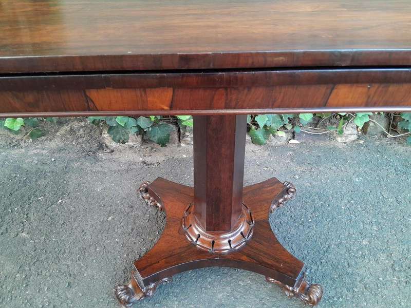 A Victorian rosewood swivel and tilt CARD TABLE, on spreading hexagonal column to the concave pla...