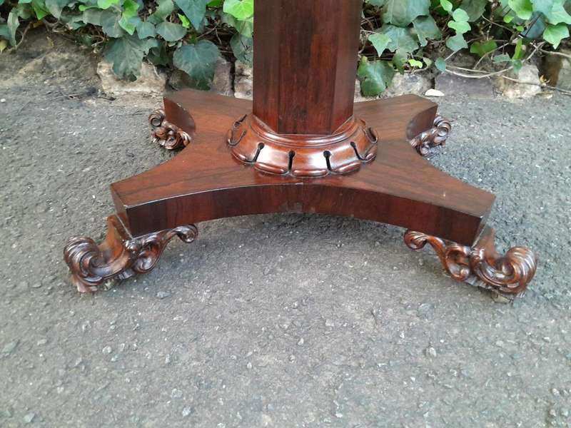 A Victorian rosewood swivel and tilt CARD TABLE, on spreading hexagonal column to the concave pla...