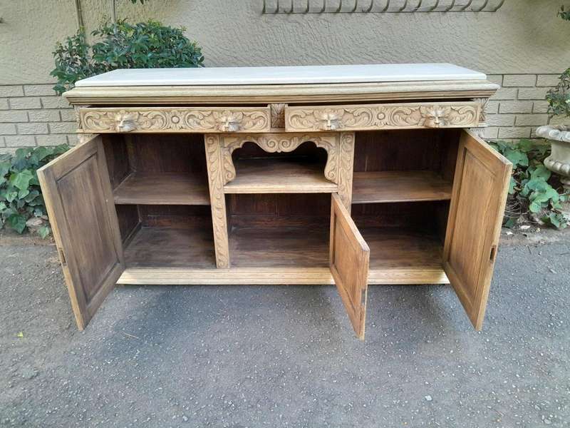 An Early 20th Century Heavily Carved Oak Sideboard / Buffet / Drinks Table With Two Drawers And T...
