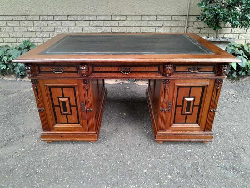 An Edwardian Circa 1910 Oak And Ebonised Desk With Gilt Tooled Green Leather Top Above Three Draw...