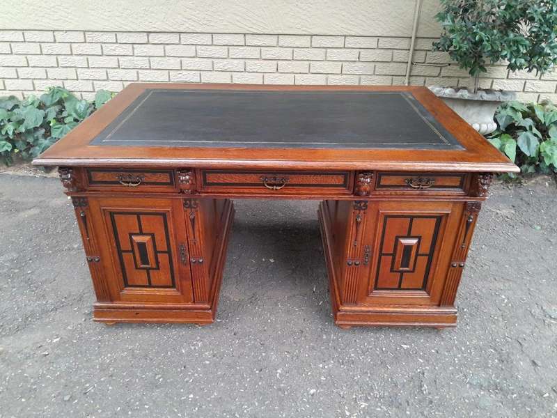 An Edwardian Circa 1910 Oak And Ebonised Desk With Gilt Tooled Green Leather Top Above Three Draw...