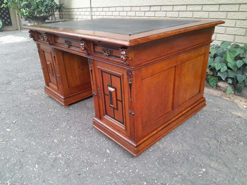 An Edwardian Circa 1910 Oak And Ebonised Desk With Gilt Tooled Green Leather Top Above Three Draw...