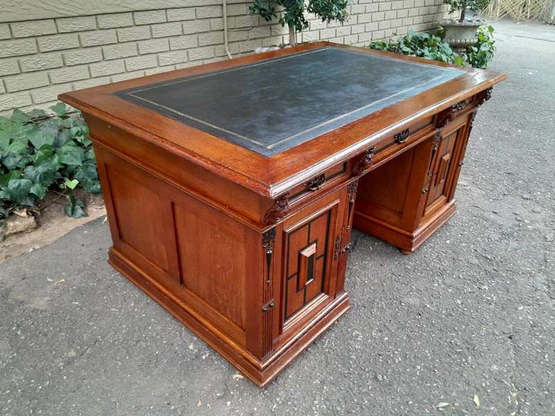 An Edwardian Circa 1910 Oak And Ebonised Desk With Gilt Tooled Green Leather Top Above Three Draw...