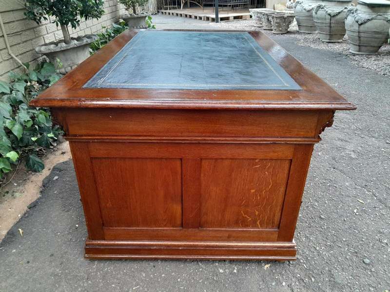 An Edwardian Circa 1910 Oak And Ebonised Desk With Gilt Tooled Green Leather Top Above Three Draw...