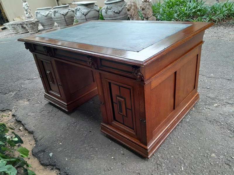 An Edwardian Circa 1910 Oak And Ebonised Desk With Gilt Tooled Green Leather Top Above Three Draw...