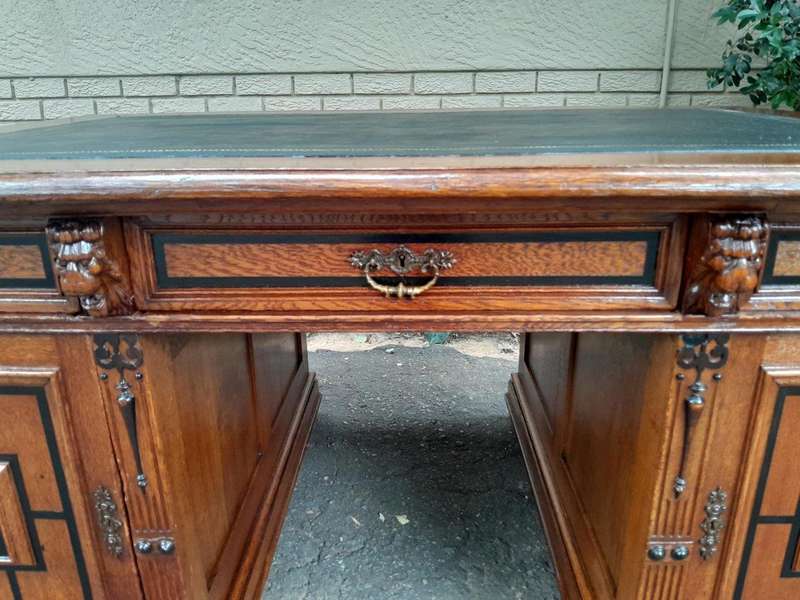 An Edwardian Circa 1910 Oak And Ebonised Desk With Gilt Tooled Green Leather Top Above Three Draw...