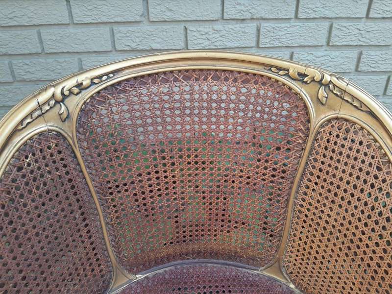 A 20TH Century French Style Gilded Rattan Bergère Chair