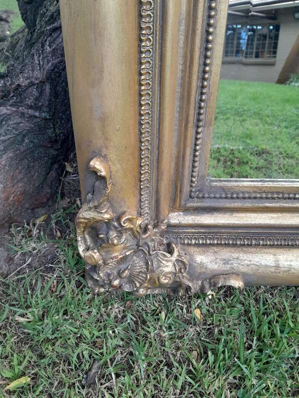 A 20th Century French Style Ornately Carved And Hand Gilded Bevelled Mirror
